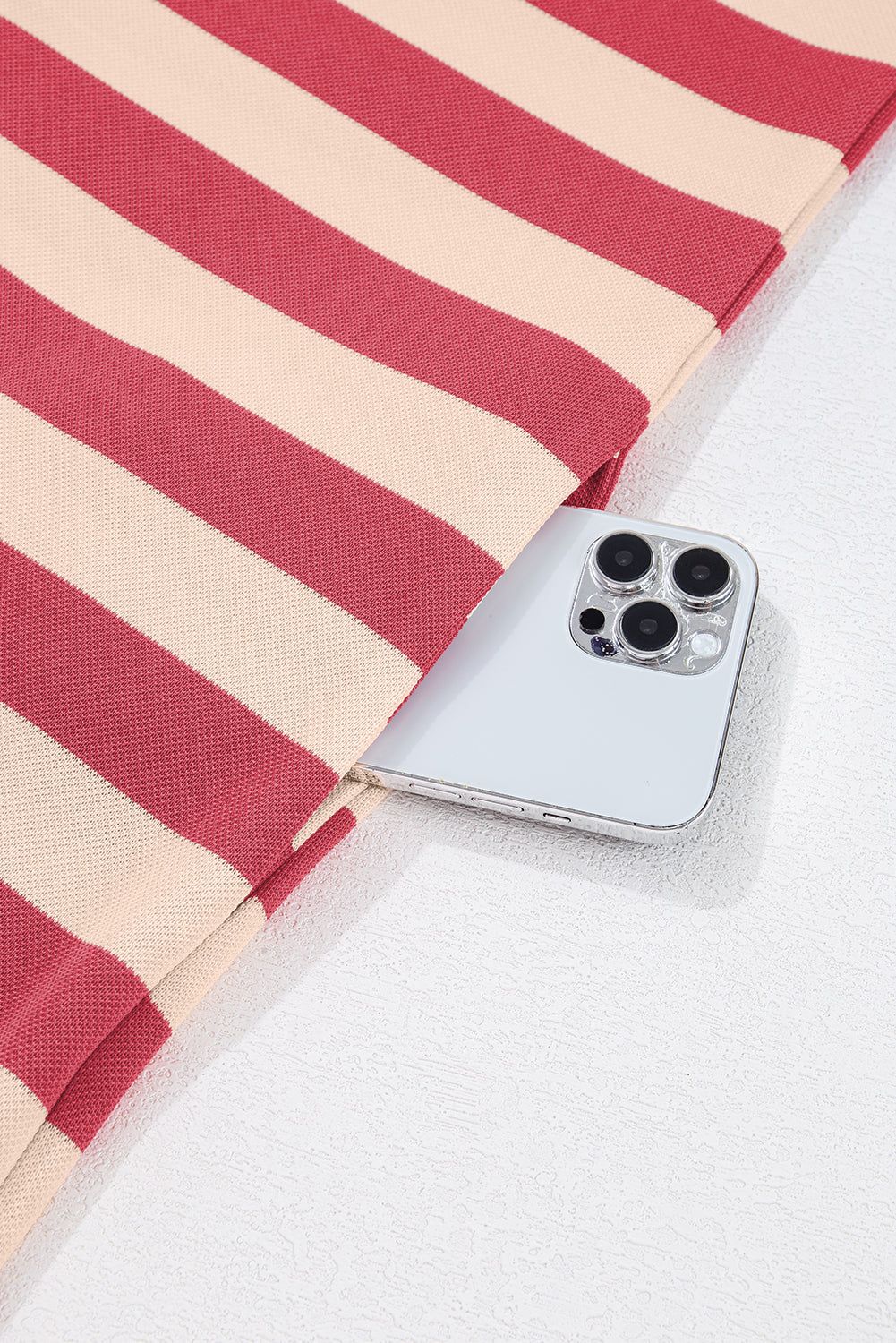 Striped mini dress fabric with phone in pocket, showcasing versatile and chic design.
