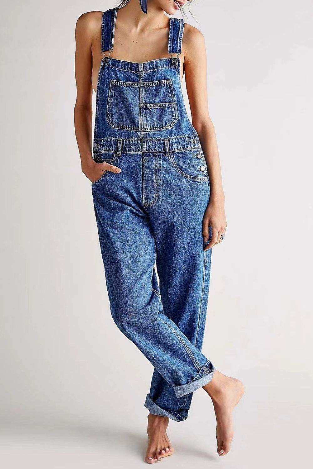 Wide strap square neck denim overalls with adjustable straps and functional pockets.