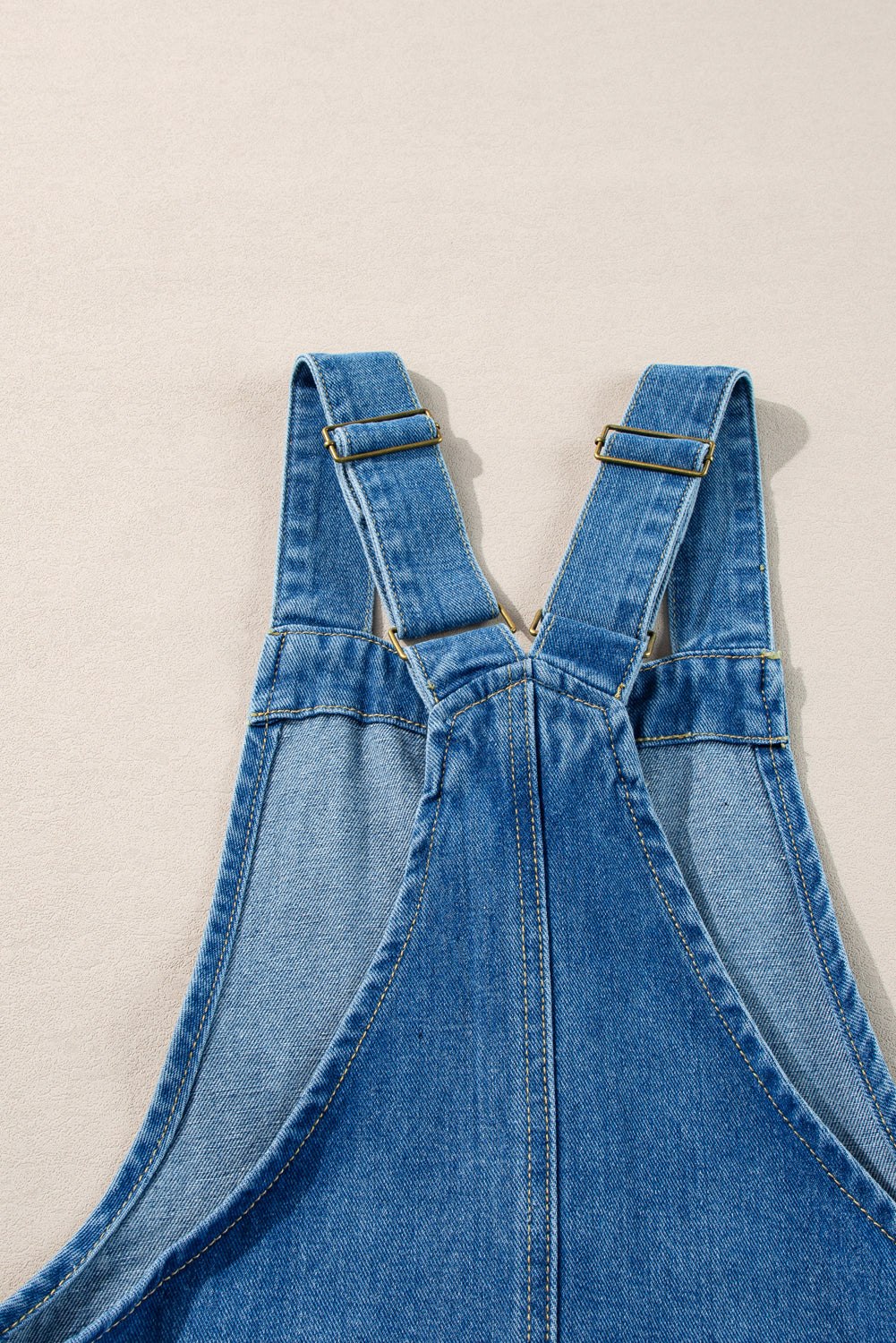 Dusk blue wide strap button front pocketed denim mini dress with adjustable straps.