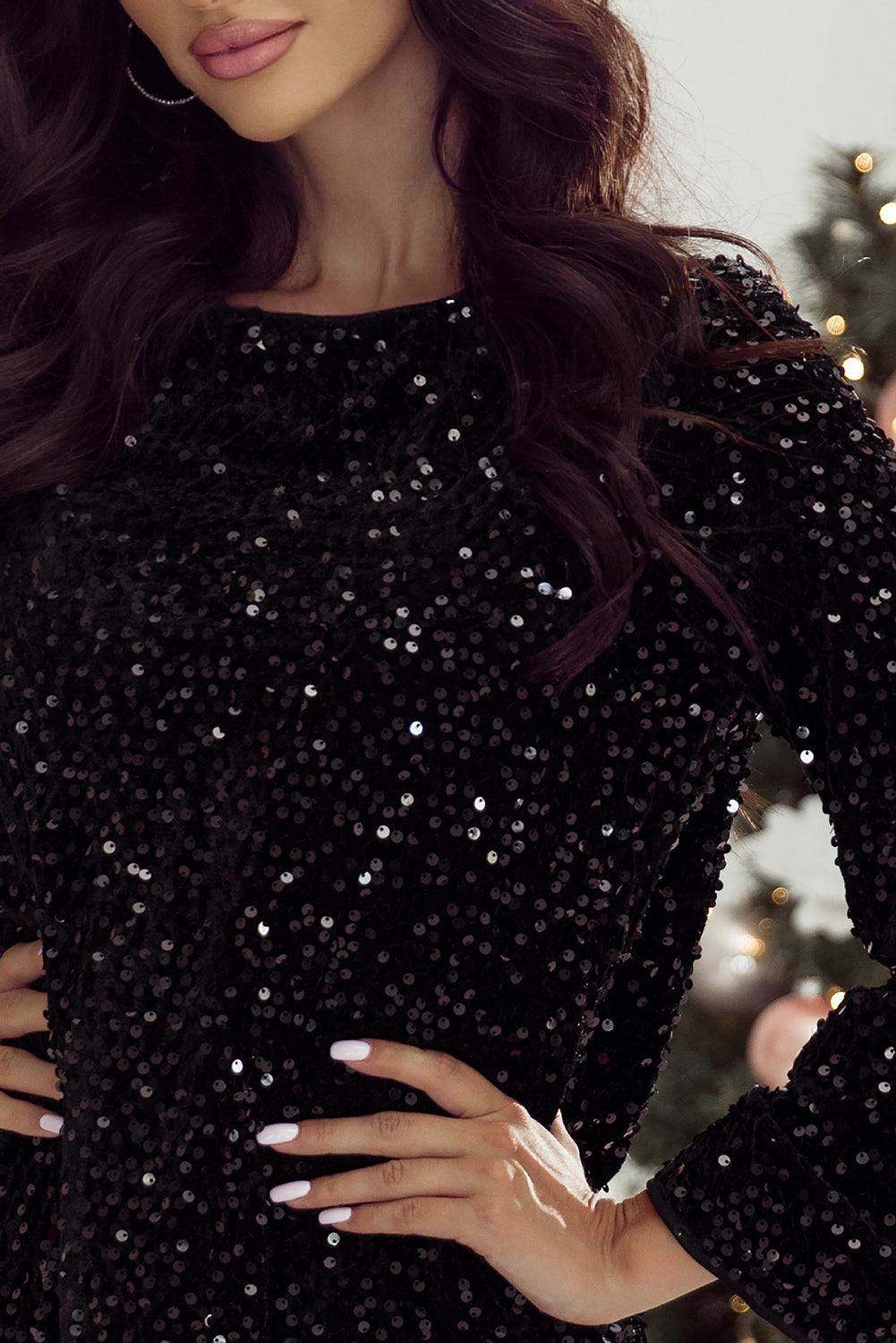 Black sequin long sleeve mini dress with chic knot cutout back and elegant bell cuffs.