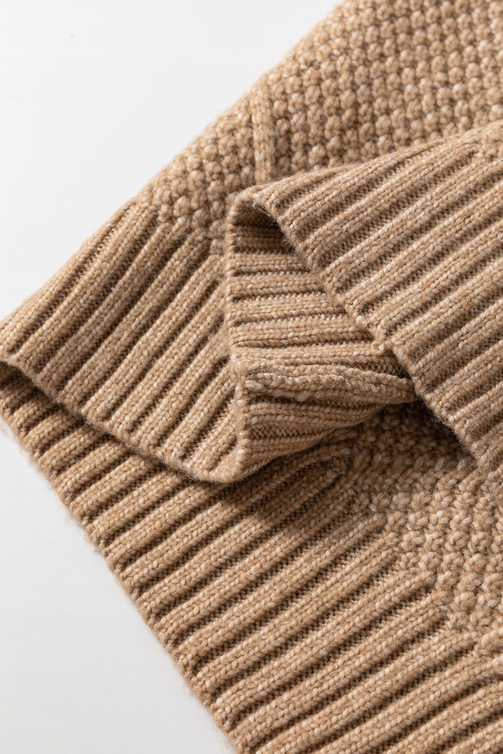 Parchment cable knit sweater dress fabric with intricate detailing and ribbed texture.