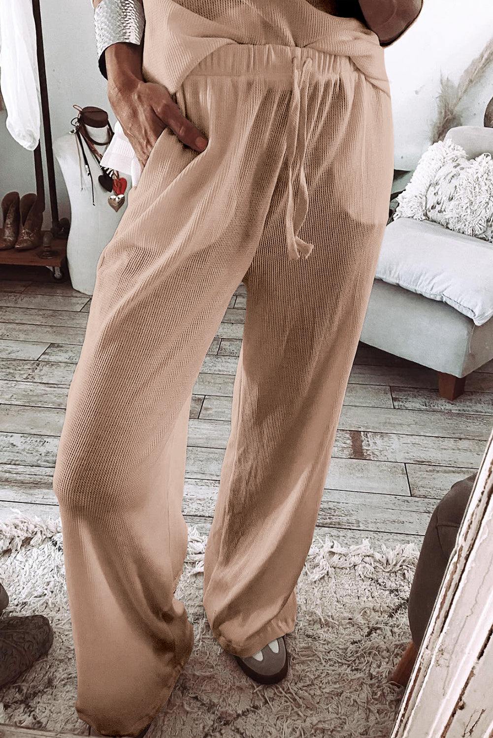 Women's parchment textured lounge set pants with elastic waistband and relaxed fit in a cozy room setting