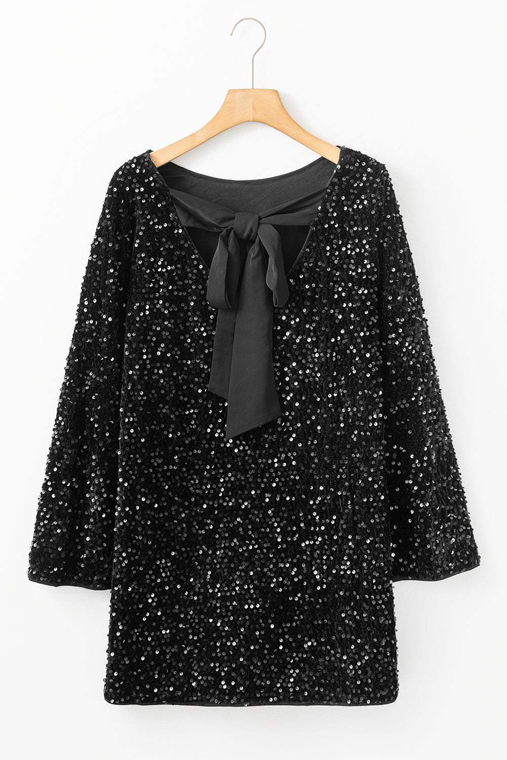 Black sequin mini dress with long sleeves and knot cutout back on hanger.