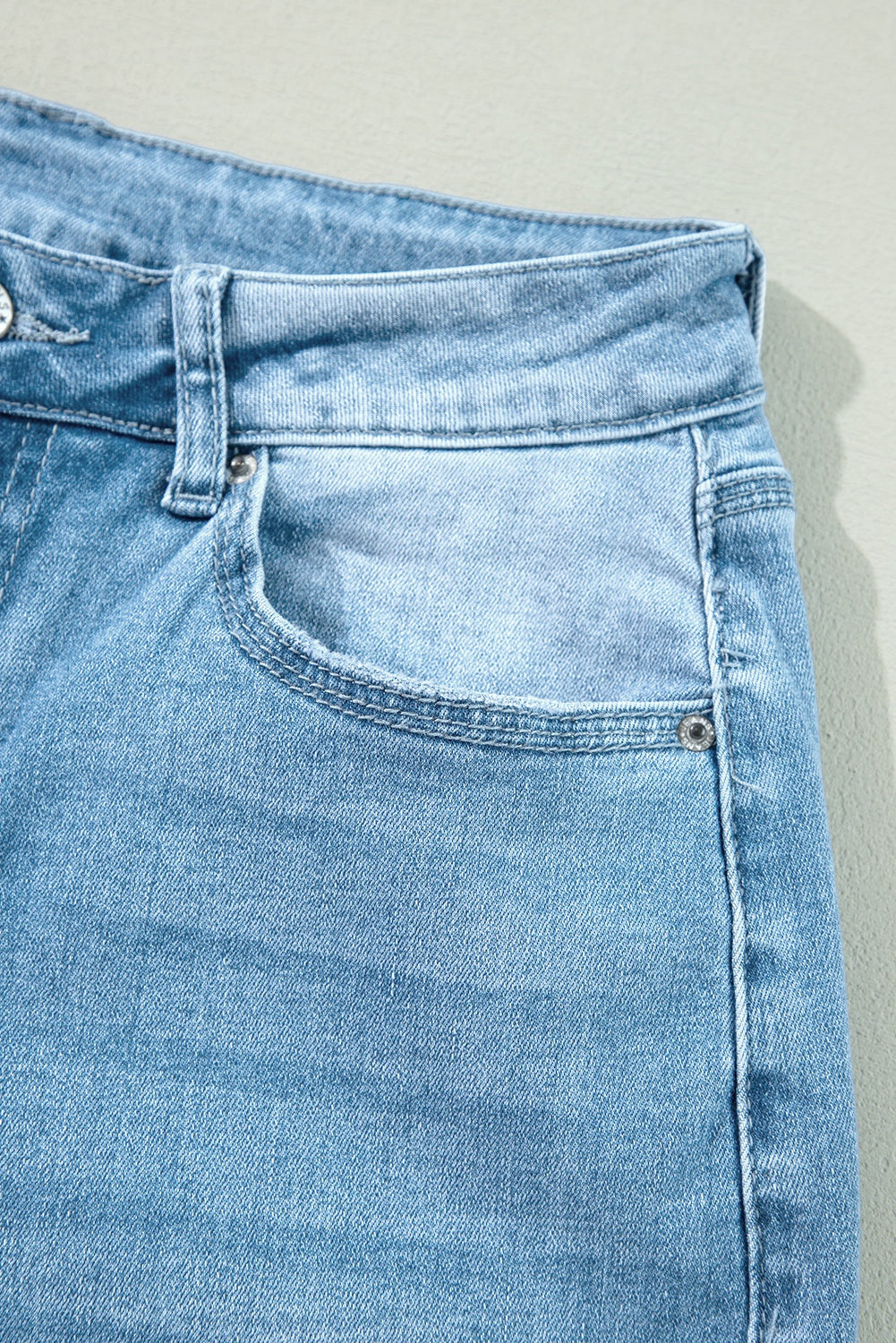 High rise slit leg jeans - product detail showing quality construction from the front pocket