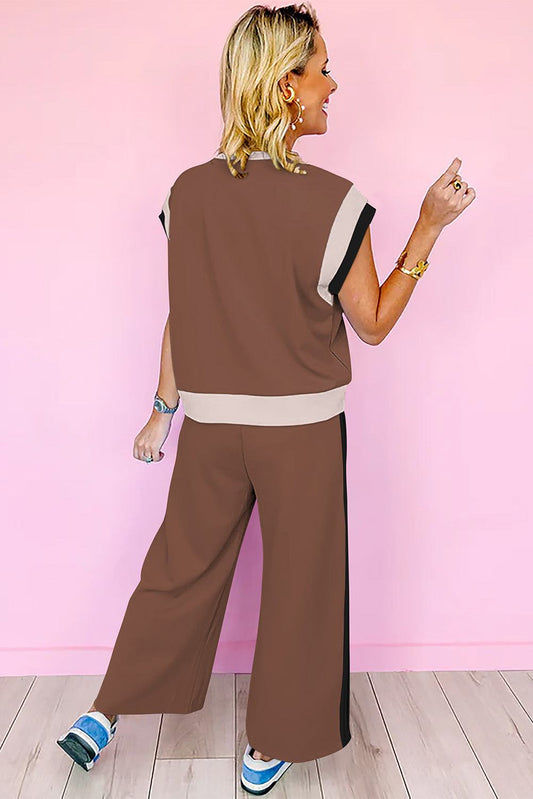 Woman wearing chestnut color block casual two-piece outfit with neutral panels against pink background