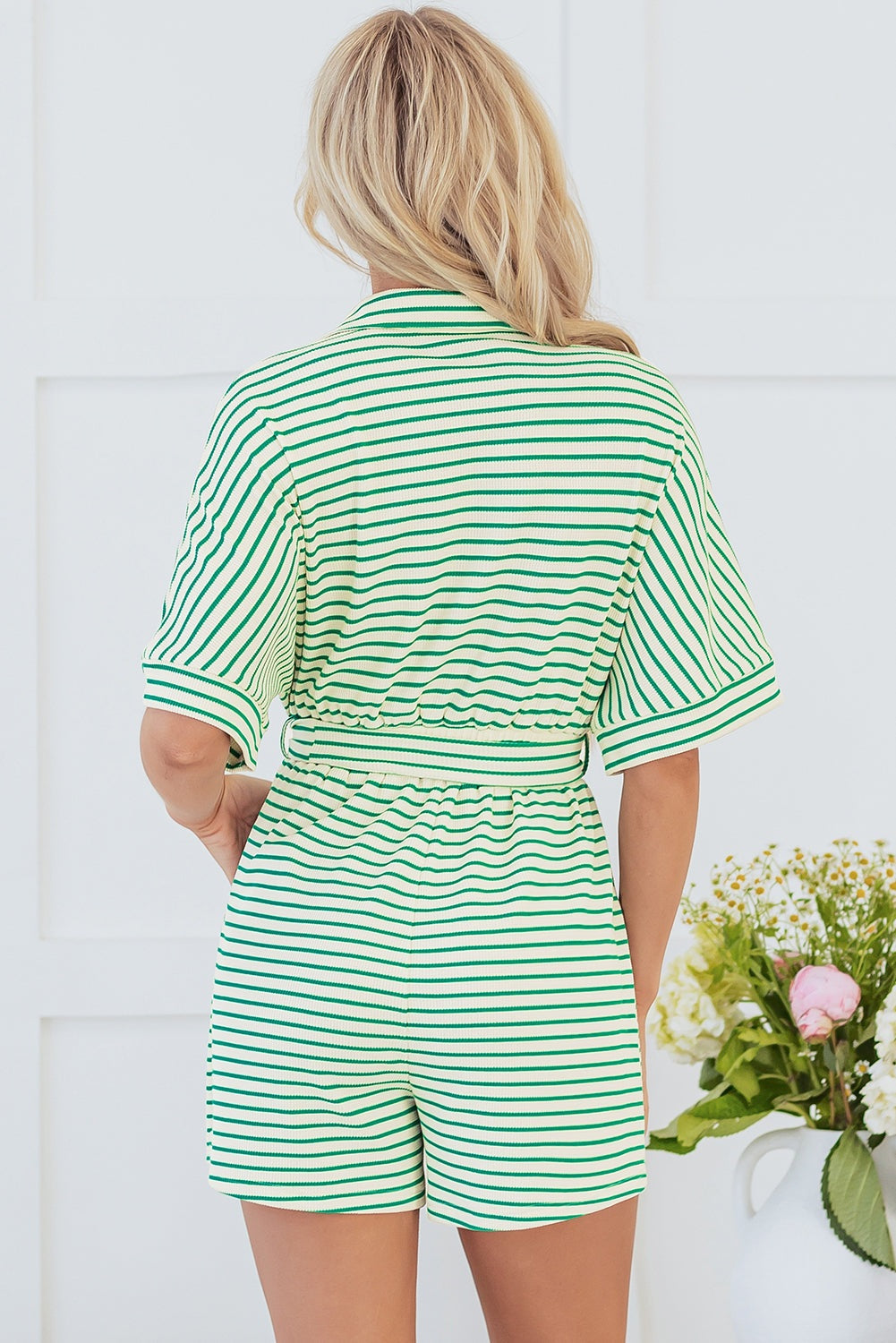 Green stripe textured short sleeve romper with waist tie.