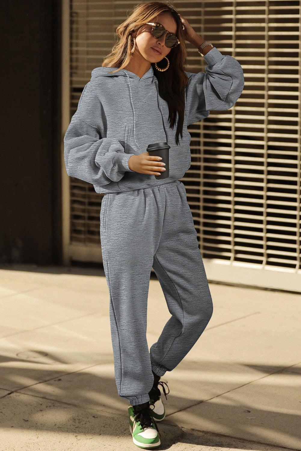 Woman relaxing in a modern gray activewear set on street