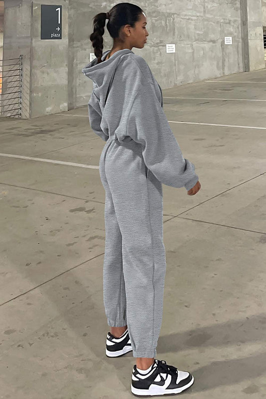 Side angle of gray drop shoulder hoodie and jogger pants set