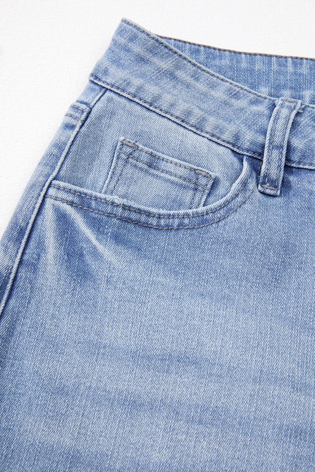 Beau Blue Mineral Wash High Waist Flared Jeans with Raw Hem and Stretch Denim.