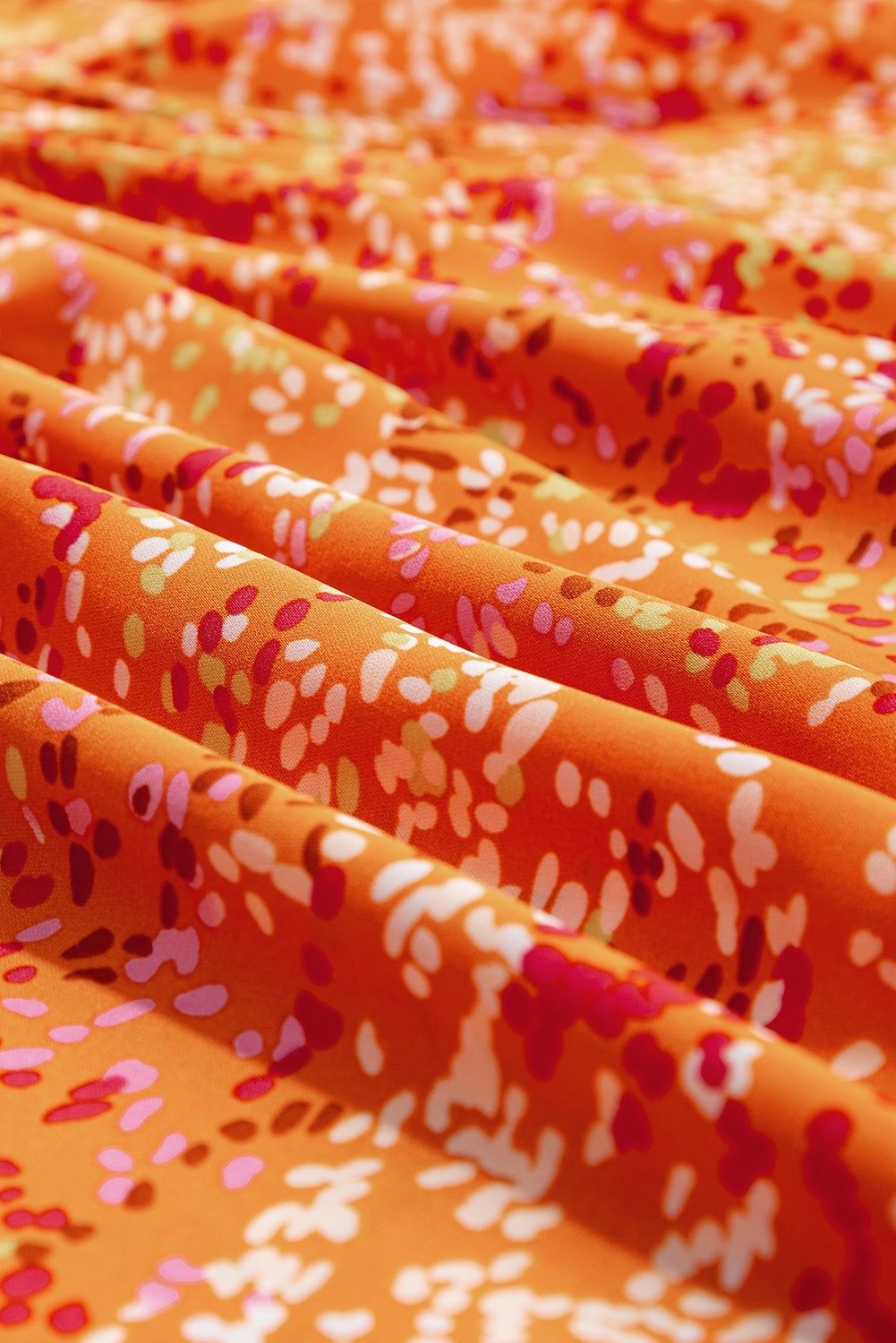 Close-up of orange babydoll blouse neckline