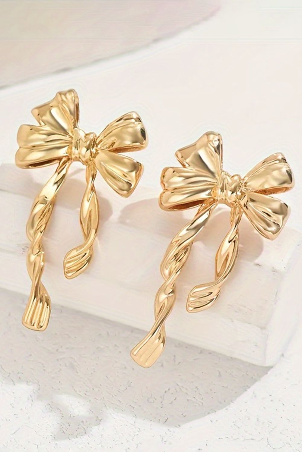 Women wearing gold bow knot stud earrings - lifestyle shot