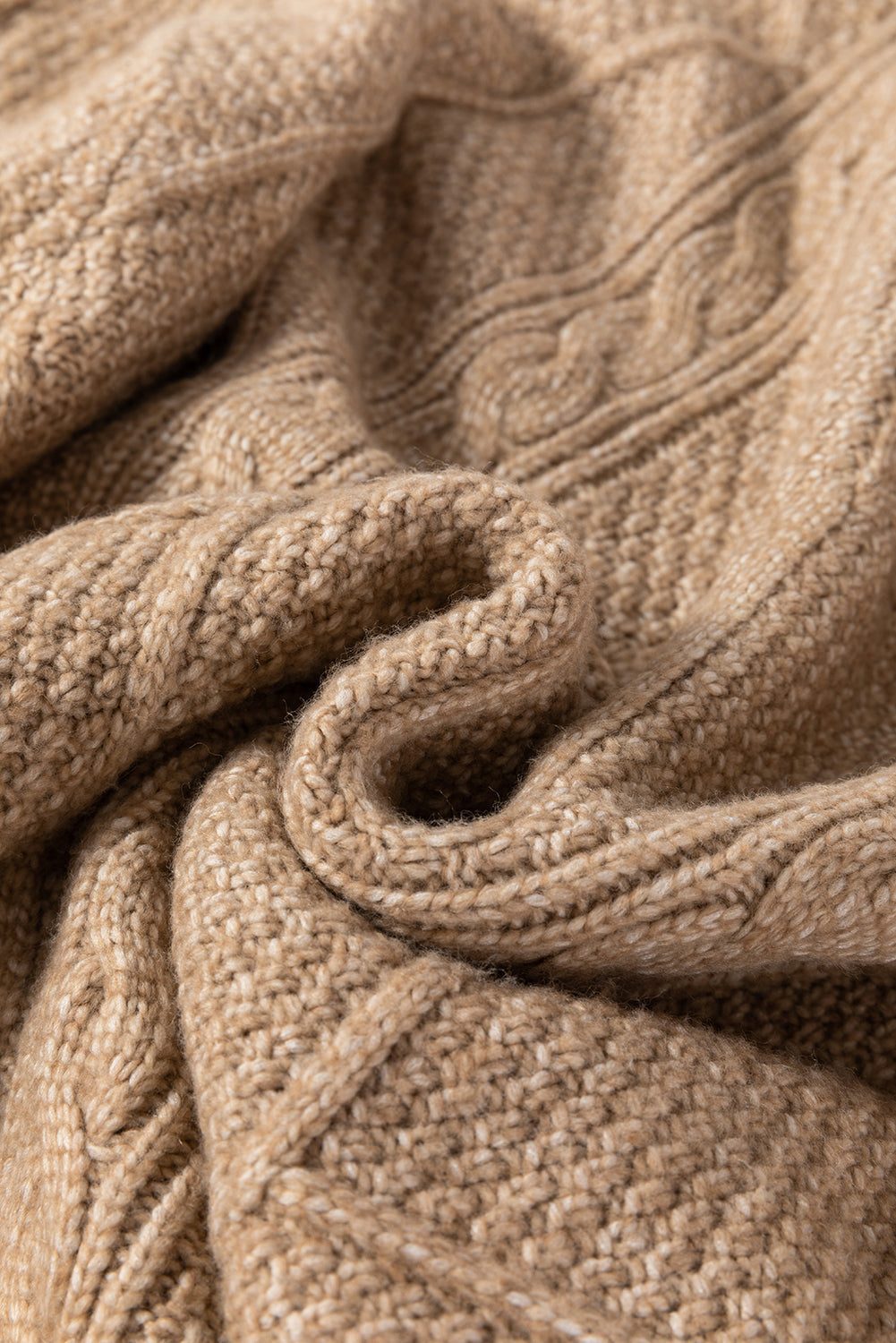 Parchment cable knit fabric texture of sweater dress.