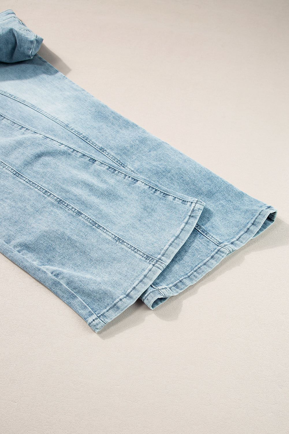 Dusk blue acid wash high waist long jeans with extra wide leg design laid flat on a neutral surface