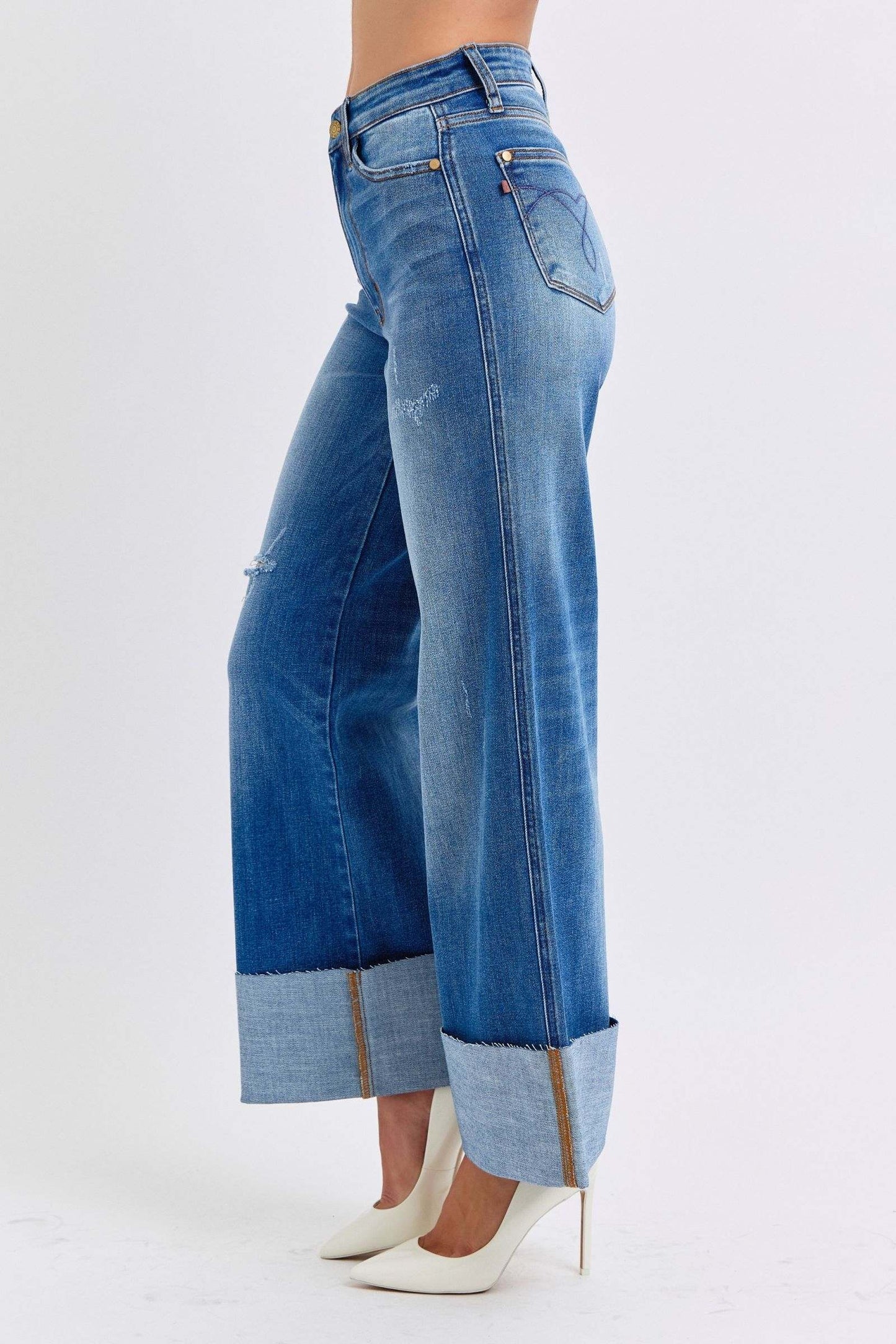 Judy Blue distressed high waist wide leg jeans showcasing stylish worn-in look with cuffed hems.