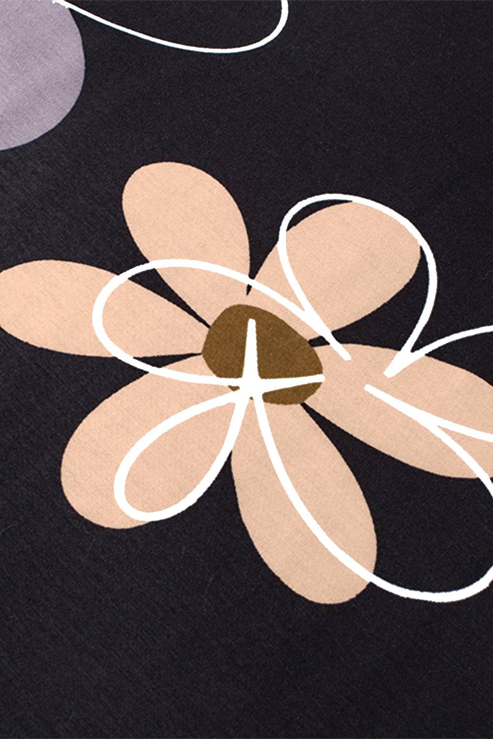 Close-up of beige and white floral print on black fabric of summer casual round neck t-shirt