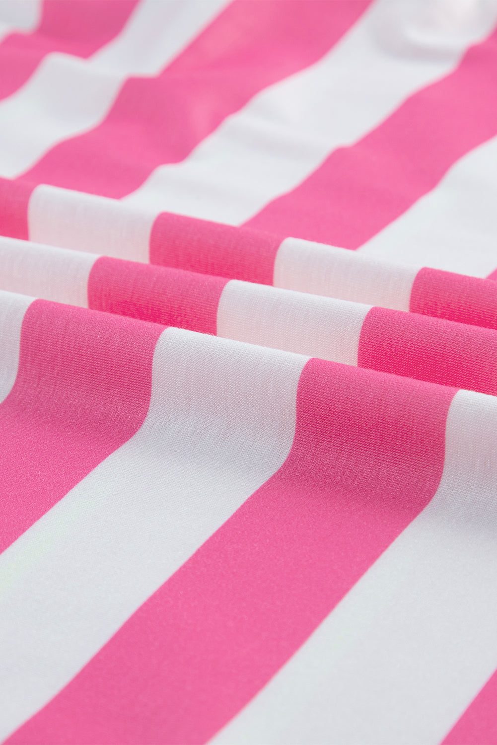 Pink and white contrast striped t-shirt fabric close-up.
