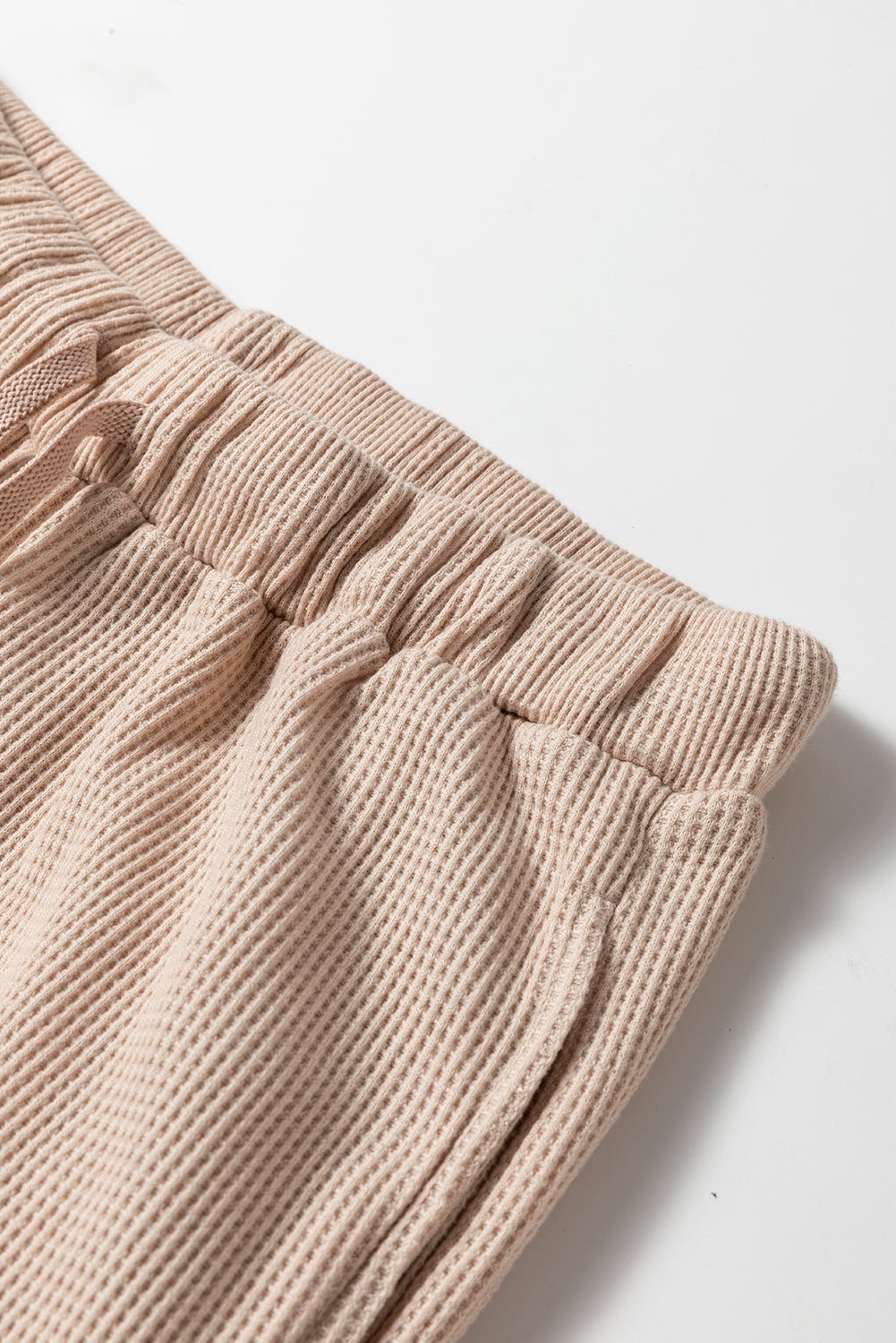 Close-up of beige Parchment Textured Lounge Set pants with elastic waistband and drawstring detailing