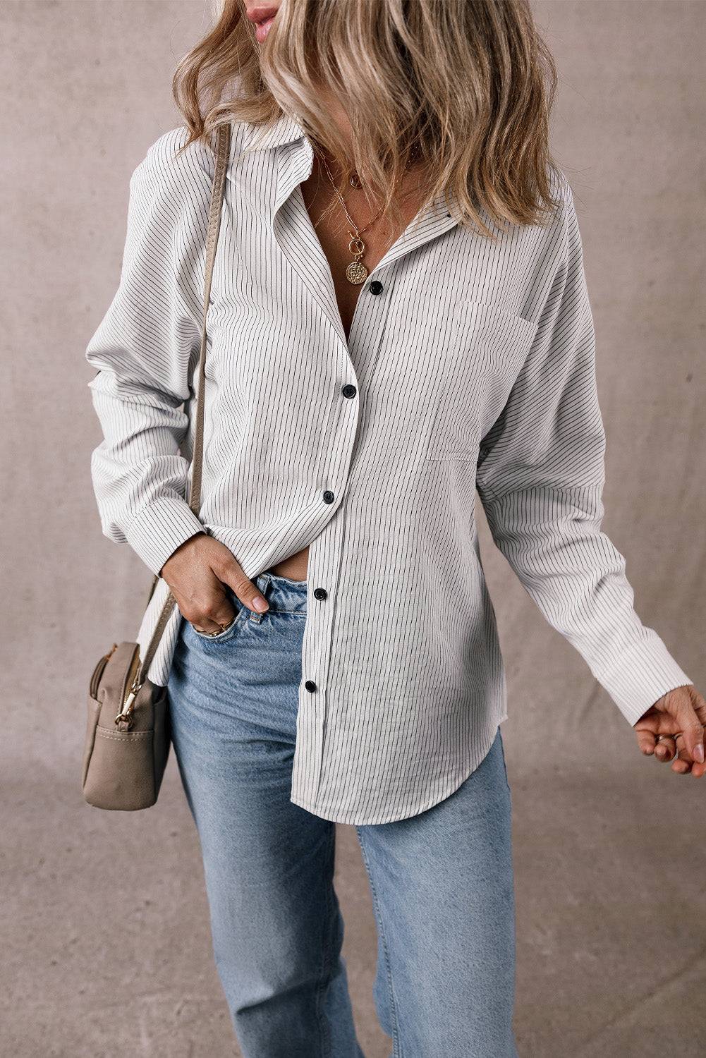Woman wearing DEAR-LOVER striped roll-tab sleeve pocketed long shirt with jeans and beige handbag