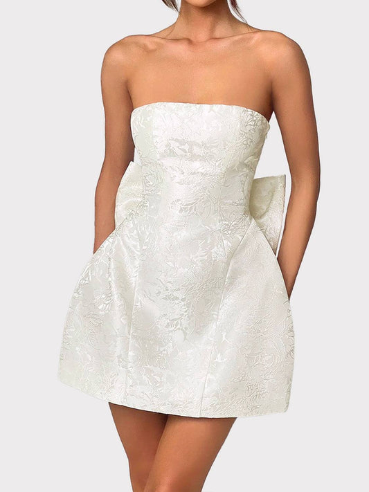 Lace-up sleeveless satin mini dress with bow in white, featuring opaque polyester fabric.