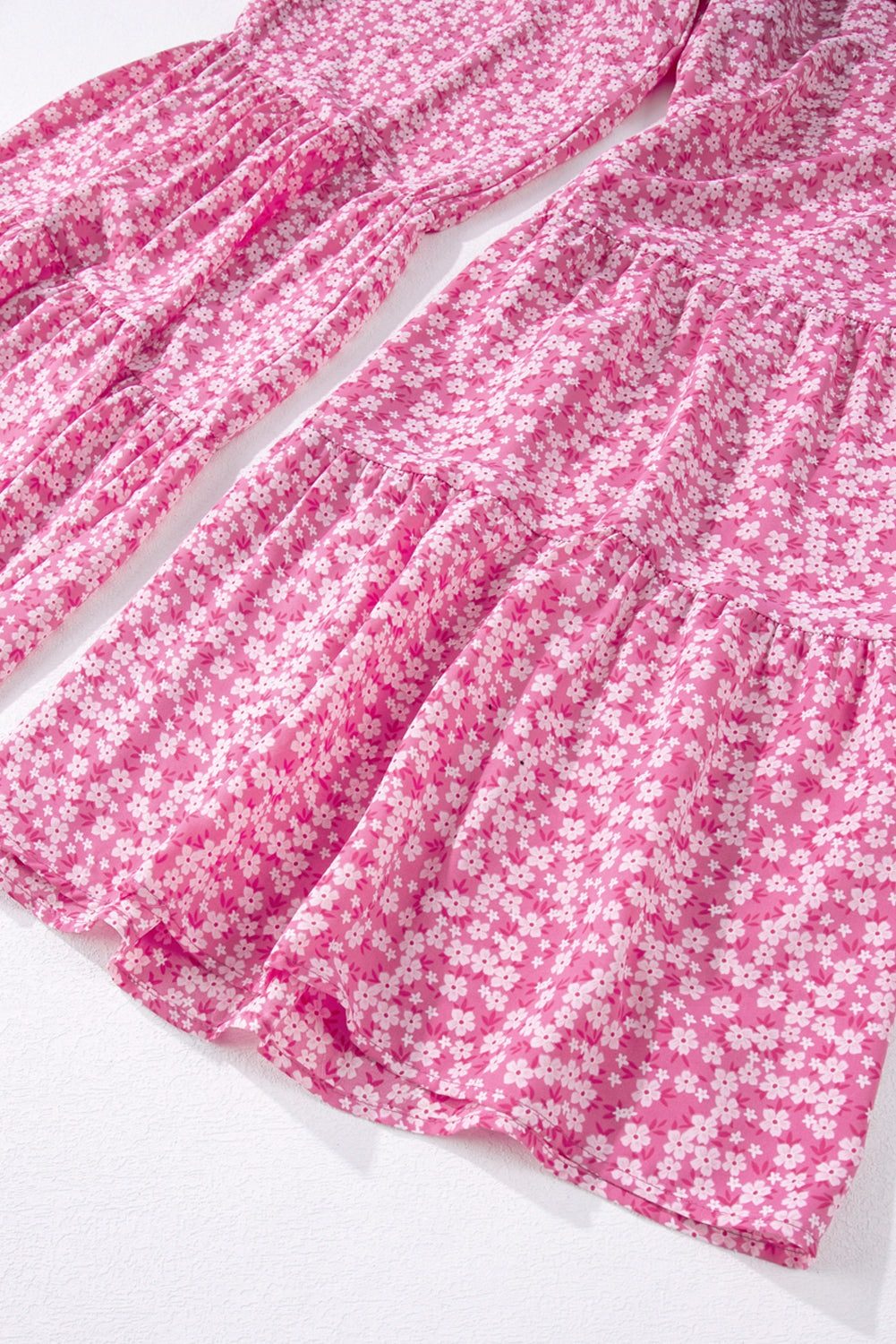 Pink floral wide leg jumpsuit with smocked bodice and adjustable thin straps