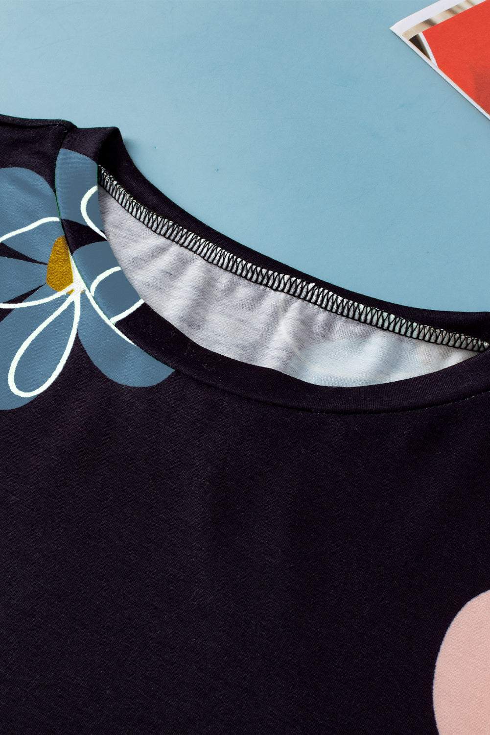 Black casual round neck t-shirt with vibrant summer flower print on black background
