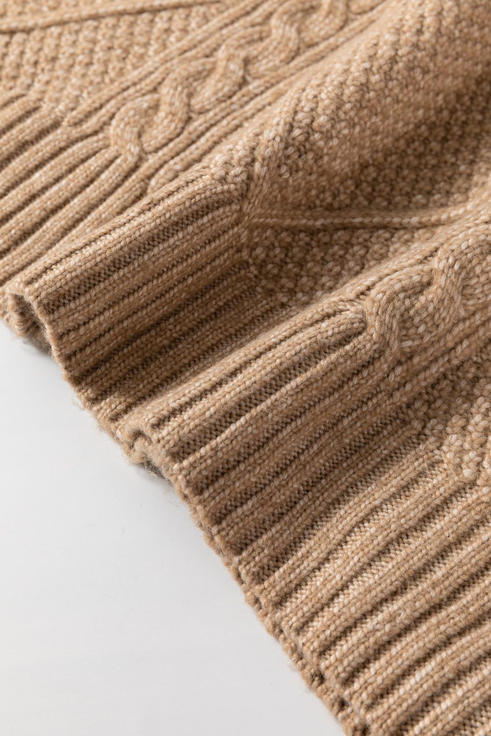 Parchment cable knit drop shoulder sweater dress detail showing intricate knitting pattern.