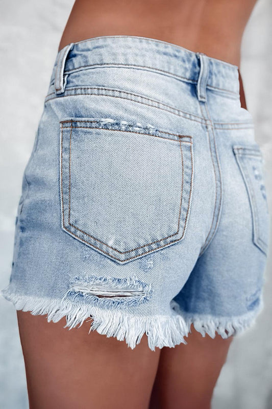Light blue distressed high waist denim shorts with ripped detailing and frayed hem.
