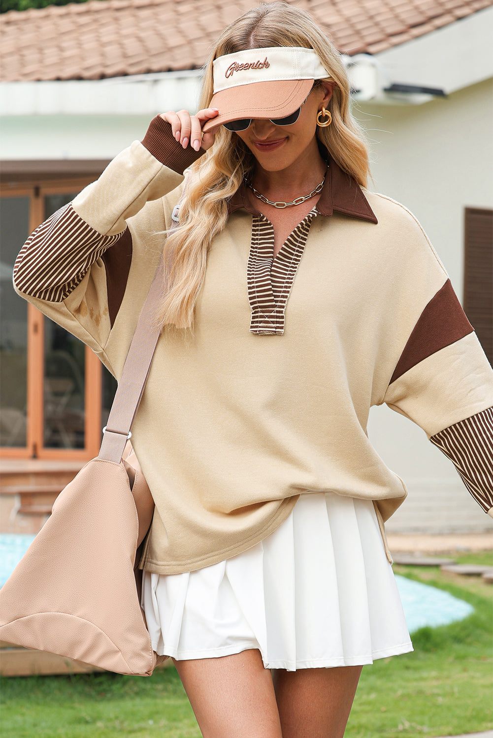 Light French Beige colorblock sweatshirt with striped patchwork and contrast collar worn with white skirt and beige visor