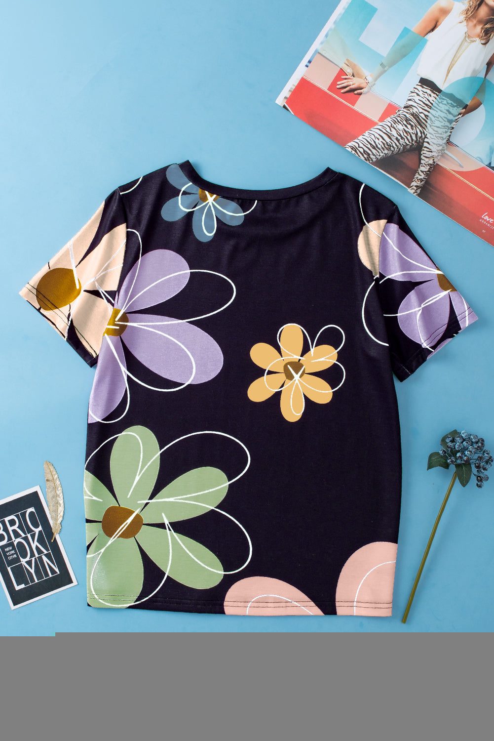 Black round neck t-shirt with vibrant summer floral print in pastel colors, casual women's top