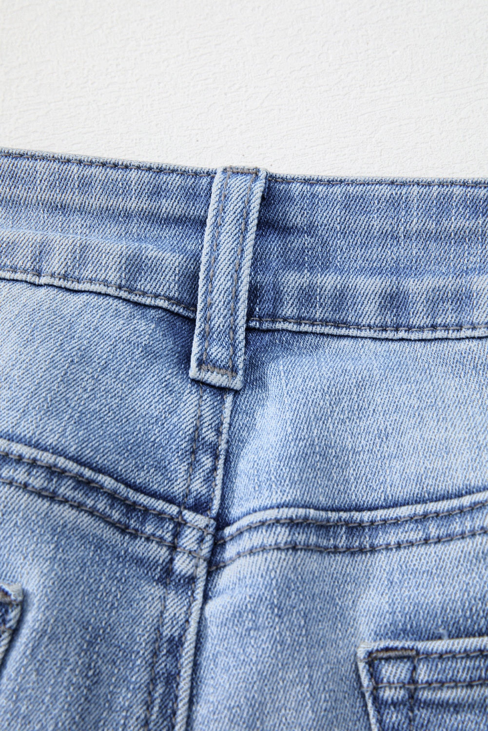 High waist flared denim featuring mineral wash and raw edge
