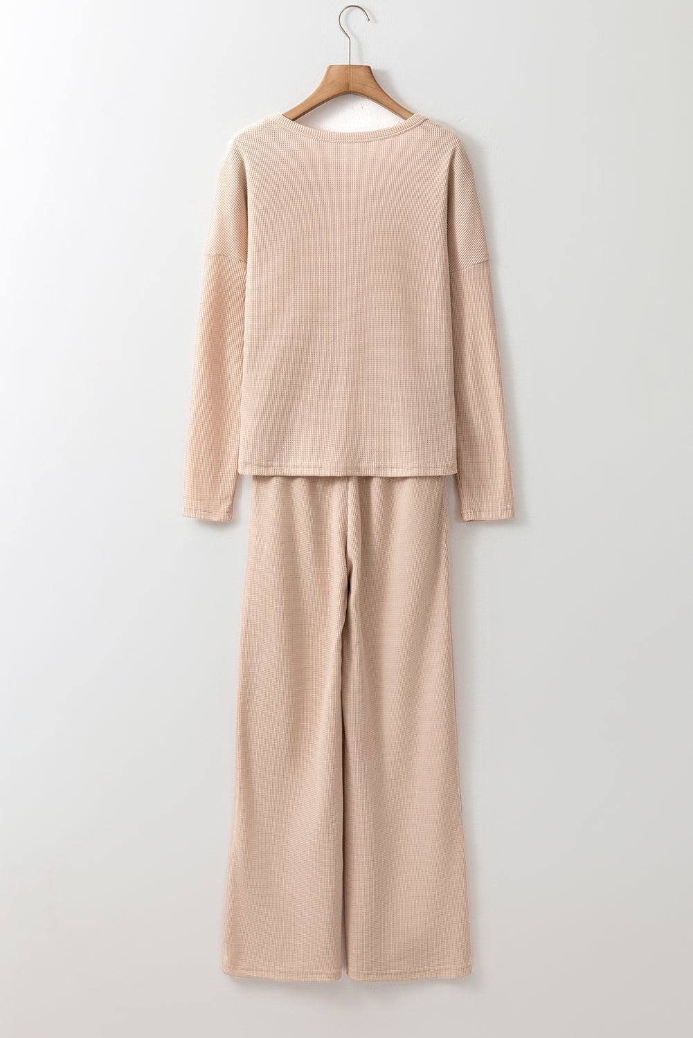 Beige Parchment Textured Lounge Set with relaxed top and tapered pants on hanger