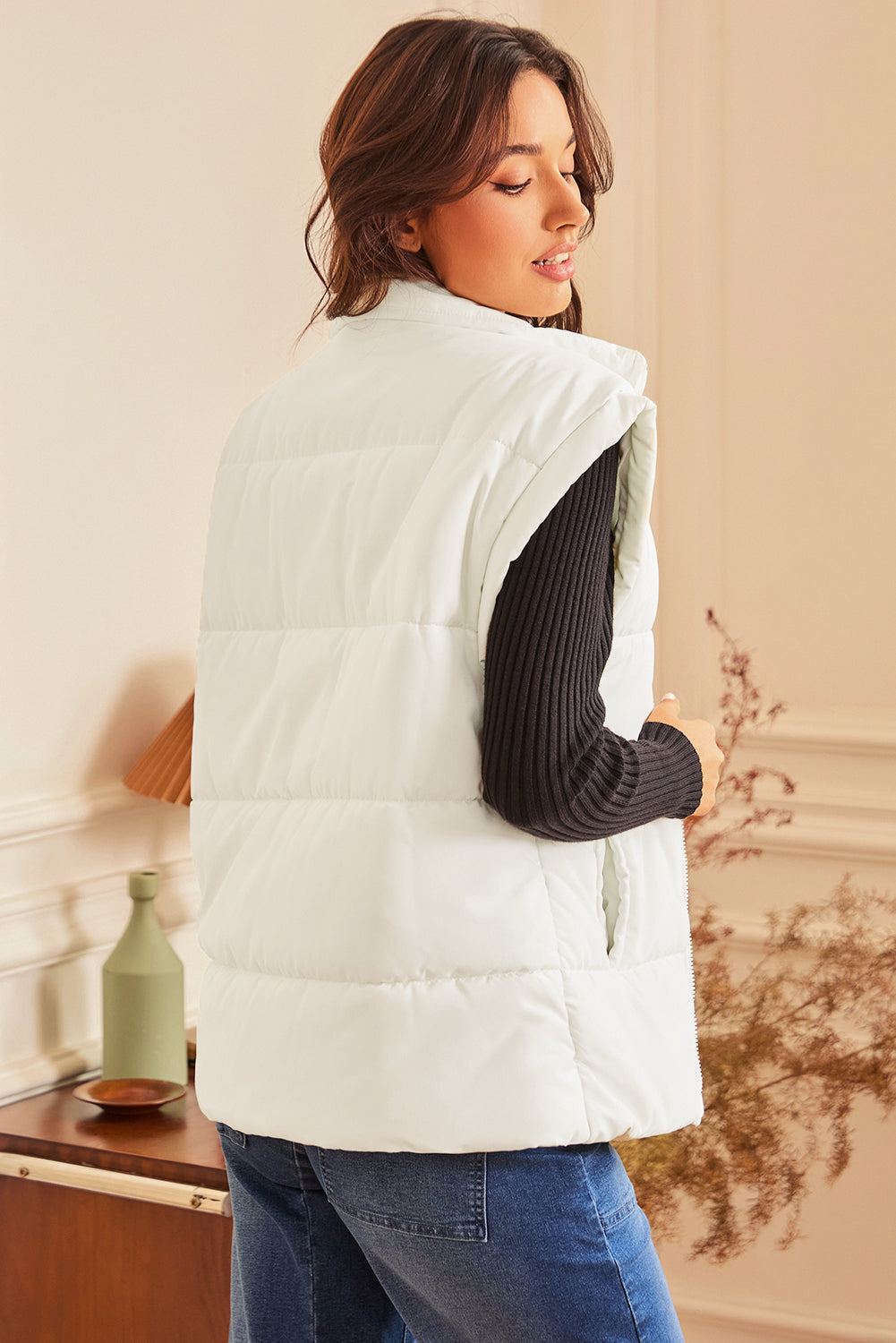Woman wearing Solid Zipper Stand Neck Oversized Puffer Vest, showcasing back view, perfect for layering and cold weather.