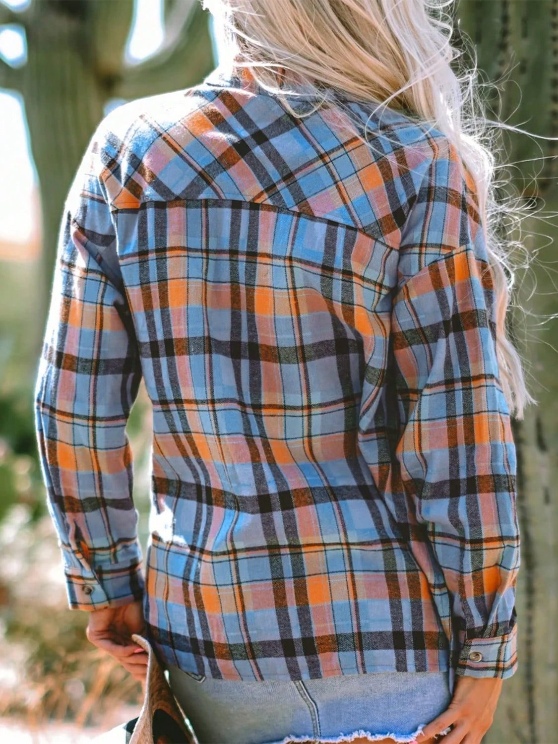 Plaid collared neck long sleeve shirt with blue and orange design.