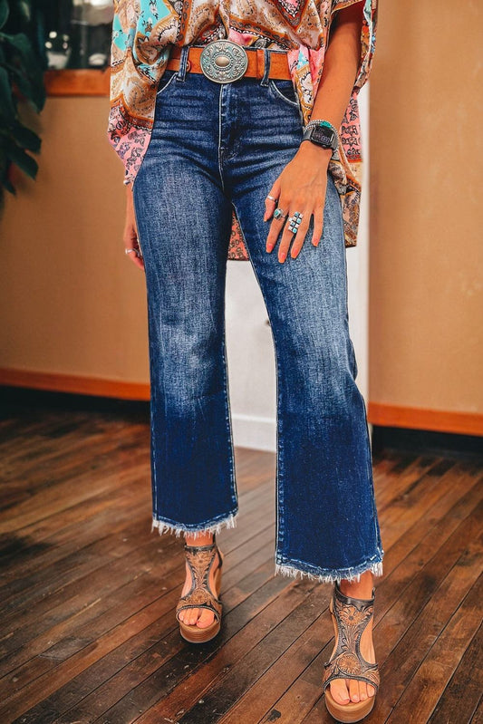 Sail blue mineral wash jeans featuring raw hem and flared leg silhouette