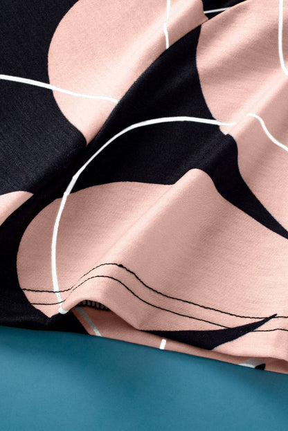 Close-up of black summer T-shirt with pink flower print and white lines, soft breathable fabric with casual round neck design.