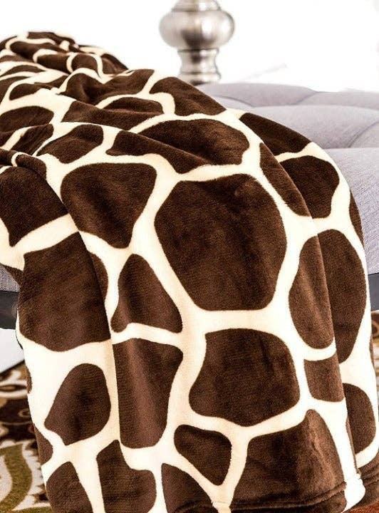 Super soft cozy giraffe print flannel blanket on bed.