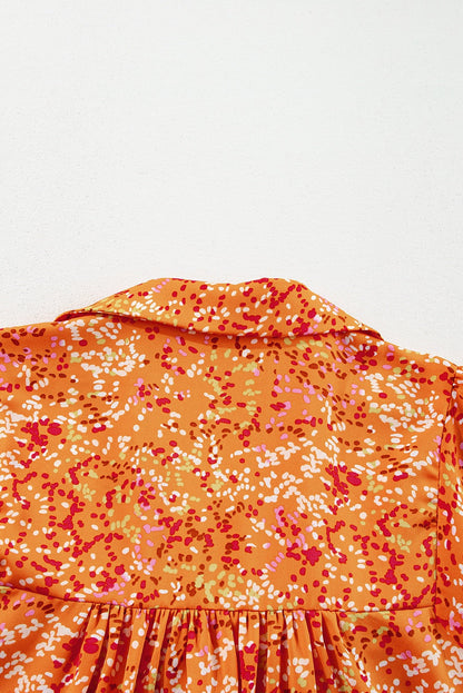 Orange abstract print babydoll blouse, back view showing collar and fabric detail.