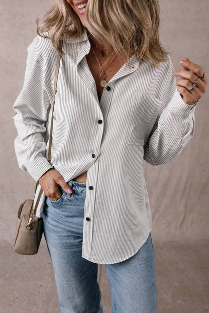 Woman wearing a DEAR-LOVER Stripe Roll-tab Sleeve Shirt with black buttons and light blue jeans