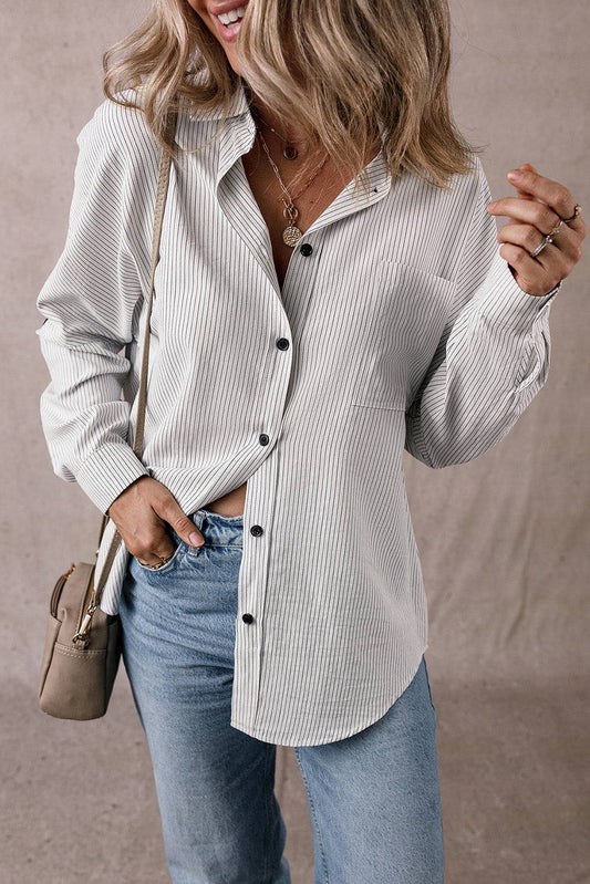 Woman wearing a DEAR-LOVER Stripe Roll-tab Sleeve Shirt with black buttons and light blue jeans