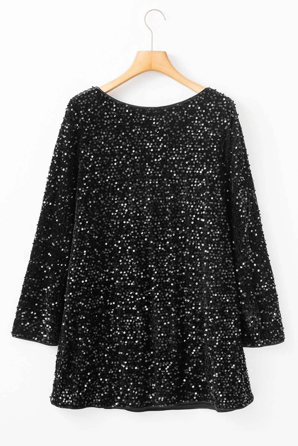 Black sequin long sleeve mini dress with knot cutout back on a hanger.