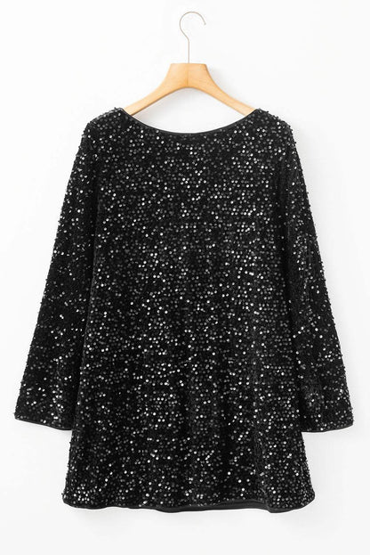 Black sequin long sleeve mini dress with knot cutout back on a hanger.