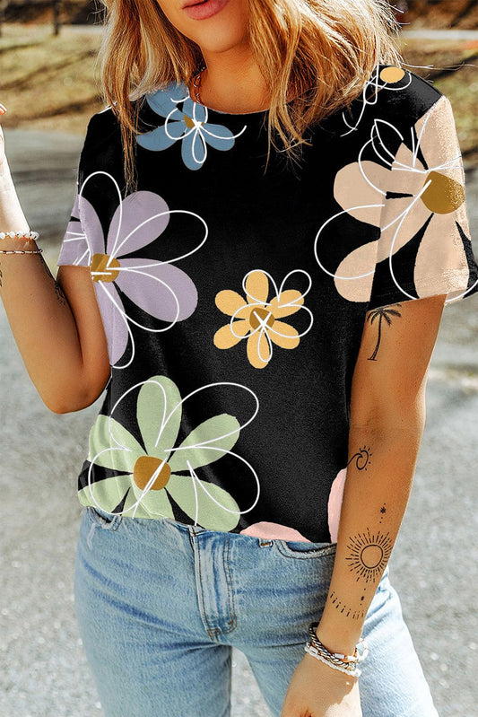 Black casual round neck t-shirt with colorful summer flower print, worn with light blue jeans