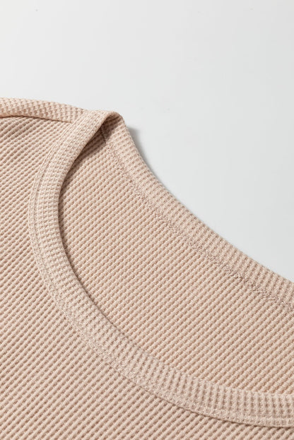 Close-up of beige Parchment Textured Lounge Set fabric on a long sleeve t-shirt neckline from a lounge set