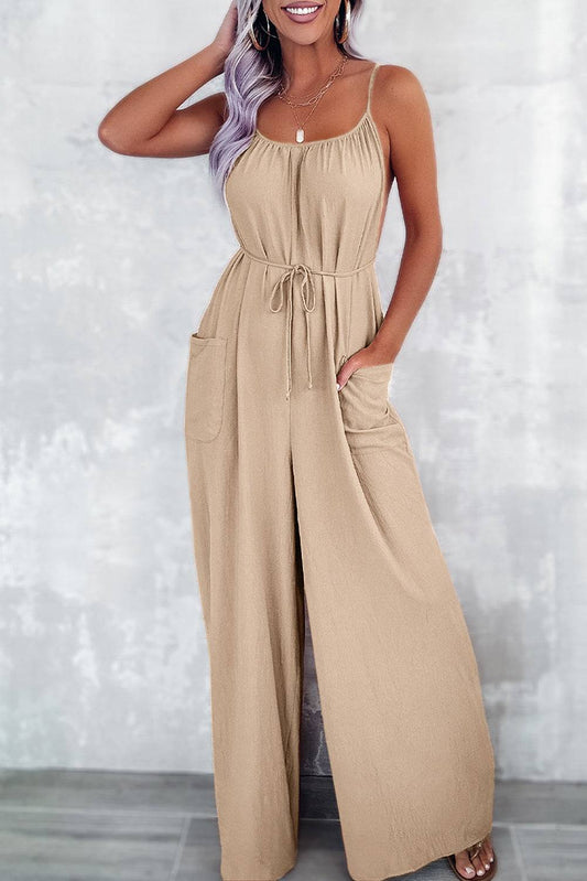 Apricot wide leg jumpsuit with pockets spaghetti straps, waist tie, and side pockets for a lightweight, elegant look