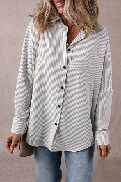Woman wearing DEAR-LOVER striped roll-tab sleeve pocketed long shirt with tunic length and black buttons