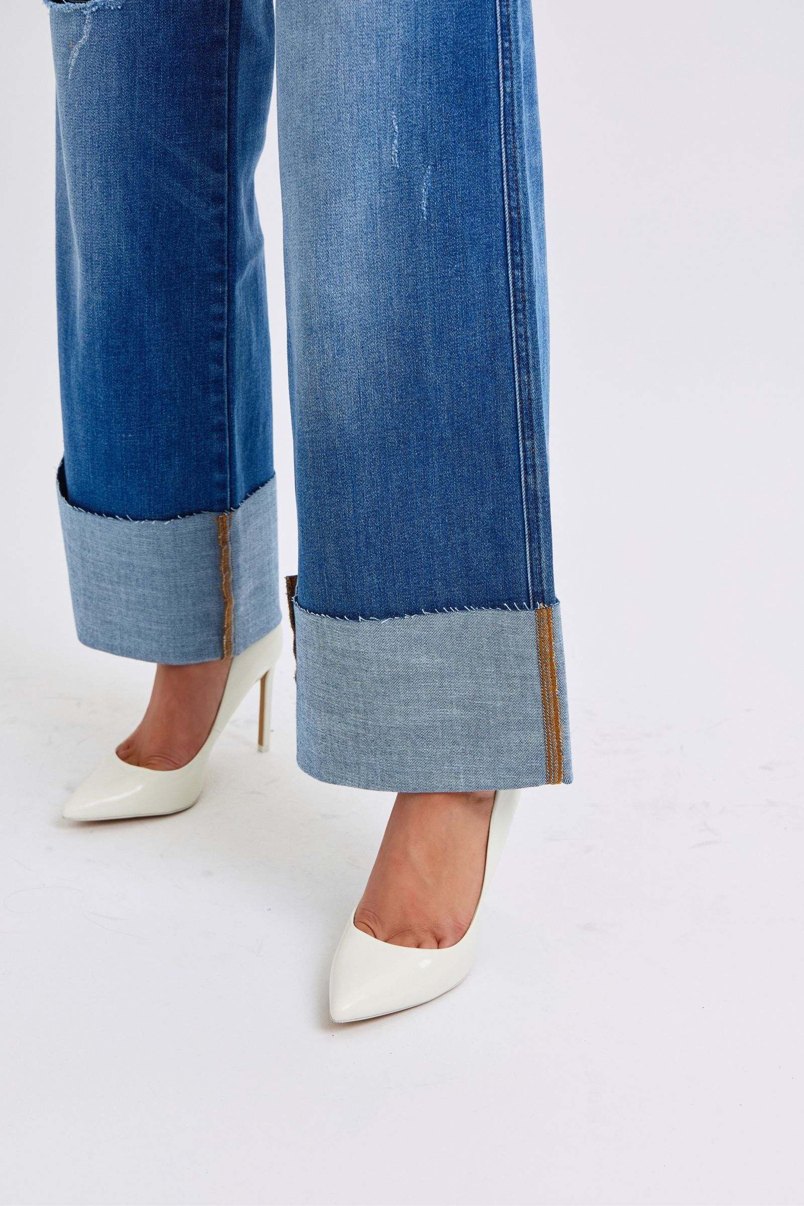 Judy Blue distressed high waist wide leg jeans with white heels.