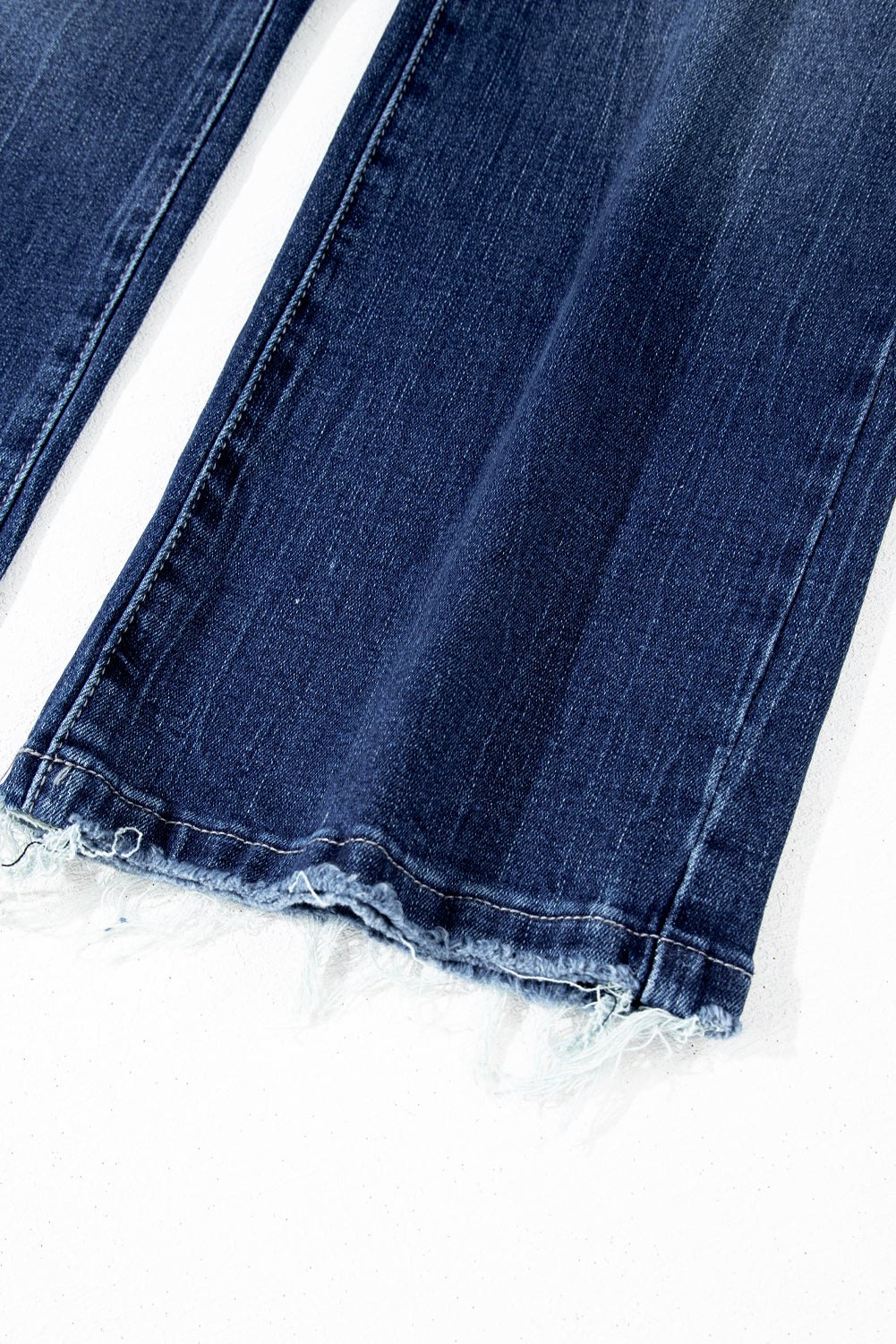 Sail blue high waist flared jeans with mineral wash finish and raw hem detail