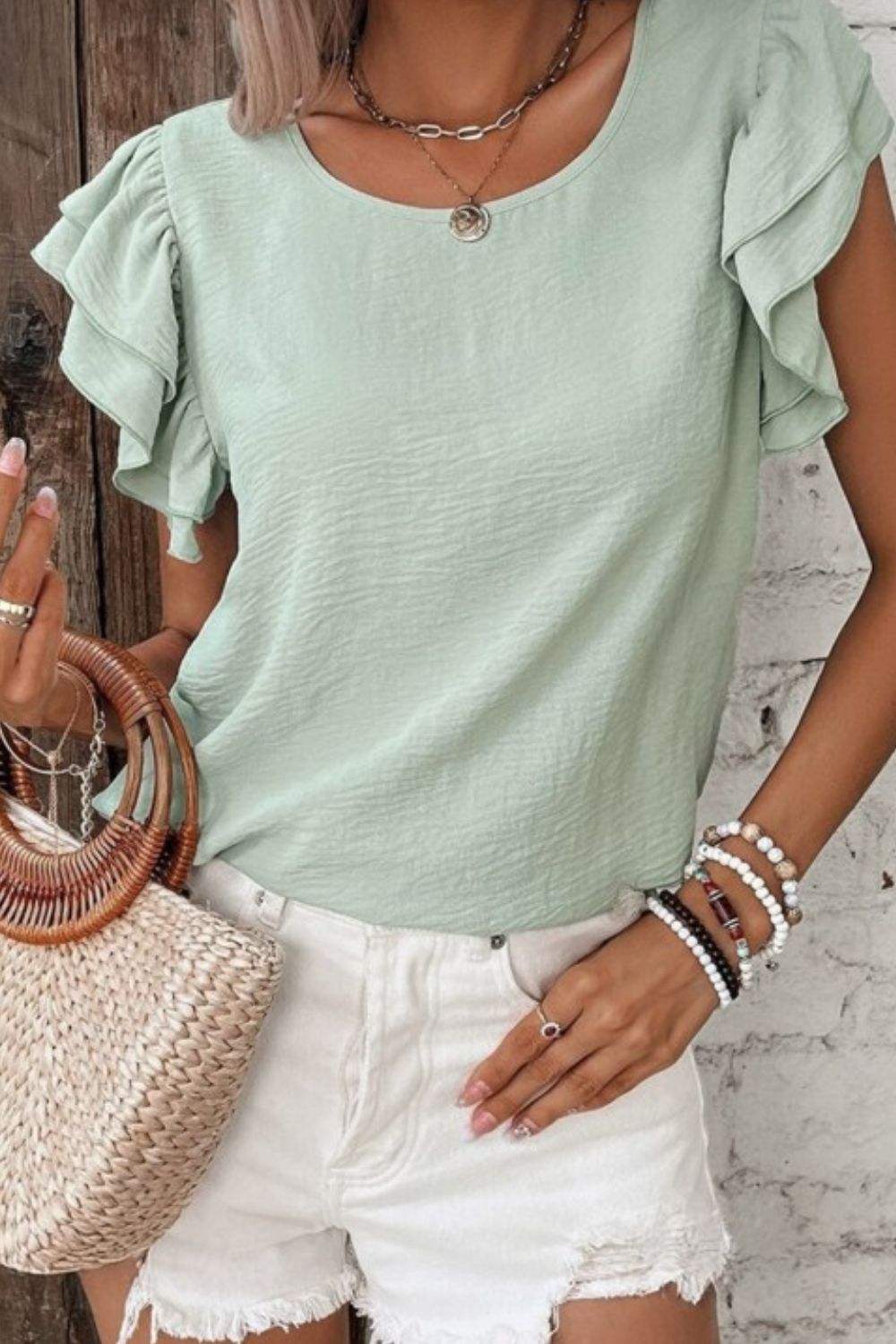 V-Neck Ruffled Cap Sleeve Blouse with feminine ruffle detailing and classic neckline.