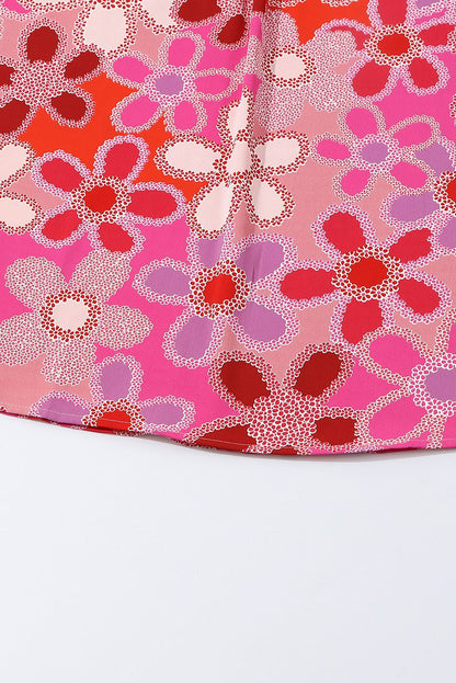 Close-up of floral pattern on the ruffled cap sleeve blouse with embroidered detail.