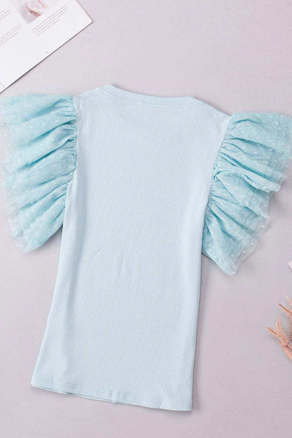 Back of soft pastel top with subtle ruffle accents and smooth finish for everyday wear